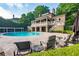 Community pool featuring lounge chairs, a covered patio, and a well-manicured lawn at 9056 Riverbend Mnr, Alpharetta, GA 30022