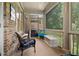 Relaxing screened porch with outdoor seating and a view of the backyard and brick exterior at 9056 Riverbend Mnr, Alpharetta, GA 30022
