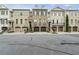 Street view of beautiful brick townhomes with garage and well-maintained lawns at 9056 Riverbend Mnr, Alpharetta, GA 30022