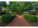 View of community street, showcasing manicured landscaping and neatly arranged homes at 9056 Riverbend Mnr, Alpharetta, GA 30022