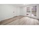 Finished basement featuring a walkout entrance with glass paneled doors, light colored walls and hardwood floors at 1007 Fairway Seven, Villa Rica, GA 30180