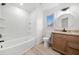 Modern bathroom featuring a tub and shower, light wood floors, and a wooden vanity with granite top at 1007 Fairway Seven, Villa Rica, GA 30180