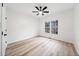Well-lit bedroom featuring light wood floors, ceiling fan, and a window at 1007 Fairway Seven, Villa Rica, GA 30180