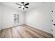 Light filled bedroom with ceiling fan, light wood floors, and natural light at 1007 Fairway Seven, Villa Rica, GA 30180