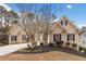 Charming brick home featuring well-manicured landscaping and a spacious driveway at 1007 Fairway Seven, Villa Rica, GA 30180