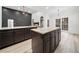 A spacious kitchen with dark cabinets, granite countertops and a large island for food preparation and entertaining at 1007 Fairway Seven, Villa Rica, GA 30180