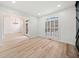 A sunlit living room featuring hardwood floors, modern lighting, and an open concept layout at 1007 Fairway Seven, Villa Rica, GA 30180
