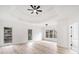 Spacious main bedroom featuring light wood floors, white walls, tray ceiling, and multiple windows for natural light at 1007 Fairway Seven, Villa Rica, GA 30180