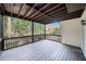 The spacious covered porch overlooks a serene wooded area, offering a tranquil outdoor living space at 1007 Fairway Seven, Villa Rica, GA 30180