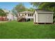 Expansive backyard view of home, shed and a large grassy yard providing space and possibilities at 1792 Center Ave, East Point, GA 30344