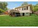 View of the home's back exterior, with a deck, and a well-maintained lawn at 1792 Center Ave, East Point, GA 30344