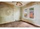 Empty bedroom with original hardwood floors and natural light from the windows at 1792 Center Ave, East Point, GA 30344