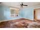 Bedroom with hardwood floors, blue walls, and a ceiling fan with ornate lighting at 1792 Center Ave, East Point, GA 30344
