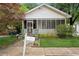 Charming white home with a screened porch and well-maintained front yard at 1792 Center Ave, East Point, GA 30344