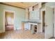 Vintage kitchen with patterned flooring, cabinets, and open doorways to other rooms at 1792 Center Ave, East Point, GA 30344