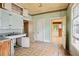 Vintage kitchen with patterned flooring, cabinets, and open doorways to other rooms at 1792 Center Ave, East Point, GA 30344