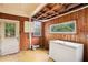 View of a partially demolished kitchen with wood paneling and natural light at 1792 Center Ave, East Point, GA 30344