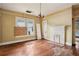 Living room featuring hardwood floors, fireplace, and windows with boarded up at 1792 Center Ave, East Point, GA 30344