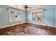 Empty living room featuring hardwood floors, windows, and blue walls at 1792 Center Ave, East Point, GA 30344