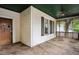 View of the screened porch featuring a ceiling fan, street view, and the front door at 1792 Center Ave, East Point, GA 30344