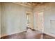 A large room with natural light featuring original hardwood floors and doors leading to other rooms at 1792 Center Ave, East Point, GA 30344