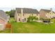 Large backyard with a gazebo, swing set, lush green grass, and siding at 3039 Tuscan Ridge Dr, Snellville, GA 30039