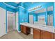 Bright bathroom with double vanity, separate tub and shower, and blue accent walls at 3039 Tuscan Ridge Dr, Snellville, GA 30039