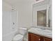 Well-lit bathroom features a shower-tub combo, a white toilet, a sink, and a vanity with modern fixtures at 3039 Tuscan Ridge Dr, Snellville, GA 30039