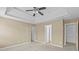Bedroom featuring a tray ceiling, ceiling fan, and two entryways at 3039 Tuscan Ridge Dr, Snellville, GA 30039
