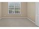 Carpeted bedroom with large window providing view to back yard at 3039 Tuscan Ridge Dr, Snellville, GA 30039