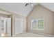 Bright bedroom featuring a high vaulted ceiling, ceiling fan, and view to the exterior at 3039 Tuscan Ridge Dr, Snellville, GA 30039