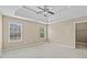 Bedroom featuring a tray ceiling, ceiling fan, and two windows at 3039 Tuscan Ridge Dr, Snellville, GA 30039