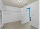 Walk-in closet with shelving and racks, adjacent to the bathroom with bright blue walls at 3039 Tuscan Ridge Dr, Snellville, GA 30039