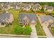Aerial view of a well-manicured home with beautiful landscaping, a wide driveway, and a welcoming front porch at 3039 Tuscan Ridge Dr, Snellville, GA 30039