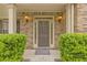Charming front entrance with a well-lit porch, manicured bushes and a stylish door at 3039 Tuscan Ridge Dr, Snellville, GA 30039