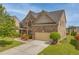 Beautiful two-story brick home with a well-manicured lawn, landscaping and attached two car garage at 3039 Tuscan Ridge Dr, Snellville, GA 30039