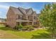 Beautiful two-story brick home with a well-manicured lawn, landscaping, and mature trees at 3039 Tuscan Ridge Dr, Snellville, GA 30039