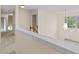 Hallway with a view of the stairs and landing with neutral colors at 3039 Tuscan Ridge Dr, Snellville, GA 30039