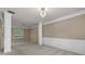 Spacious living room with decorative columns, wainscoting, plush carpeting, and a crystal chandelier at 3039 Tuscan Ridge Dr, Snellville, GA 30039