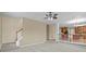 Neutral living area with adjacent staircase and view to kitchen and dining area at 3039 Tuscan Ridge Dr, Snellville, GA 30039