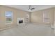 The living room boasts a fireplace, neutral paint, three windows, and carpet flooring at 3039 Tuscan Ridge Dr, Snellville, GA 30039