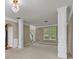 Large living room with plush carpeting, decorative columns, and view of the entry at 3039 Tuscan Ridge Dr, Snellville, GA 30039