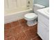 Bathroom featuring a white toilet, tub with a shower and a tiled floor at 5683 Isleworth Way, Atlanta, GA 30349