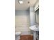 Bathroom with tub and shower combo and pedestal sink at 5683 Isleworth Way, Atlanta, GA 30349
