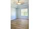Bright bedroom features trey ceilings, new floors, fresh paint, and natural light from a large window at 5683 Isleworth Way, Atlanta, GA 30349