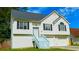Charming two-story home featuring a well-maintained lawn, a two-car garage, and eye-catching white siding with black shutters at 5683 Isleworth Way, Atlanta, GA 30349