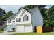 Charming two-story home features a well-maintained lawn, a two-car garage, and eye-catching white siding and black shutters at 5683 Isleworth Way, Atlanta, GA 30349