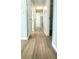 Hallway with wood grain laminate flooring leading to an open kitchen space at 5683 Isleworth Way, Atlanta, GA 30349