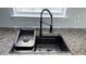 New modern kitchen sink with chrome faucet and granite counter offering lots of workspace at 5683 Isleworth Way, Atlanta, GA 30349