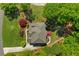 Aerial view of house with driveway, landscaped yard, mature trees and back deck at 5725 Lake Oak Lndg, Cumming, GA 30040